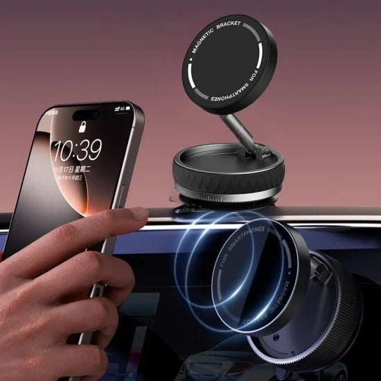 Magnetic phone holder on car dashboard with smartphone and hand holding a phone.
